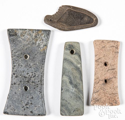 Four drilled stone items