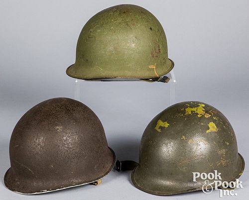 Three US WWII M1 helmets with liners