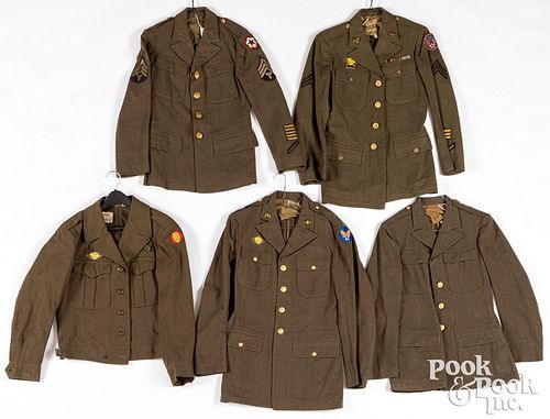 Five US WWII era military uniforms
