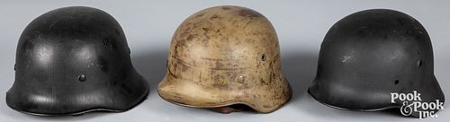 Three German WWII helmets, to include a M40