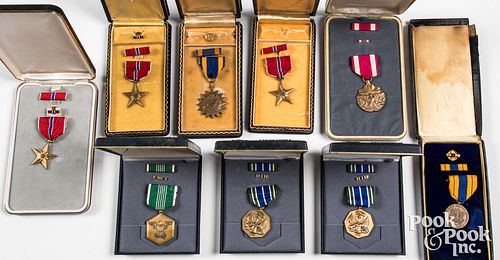 Nine US military medals, in hard cases
