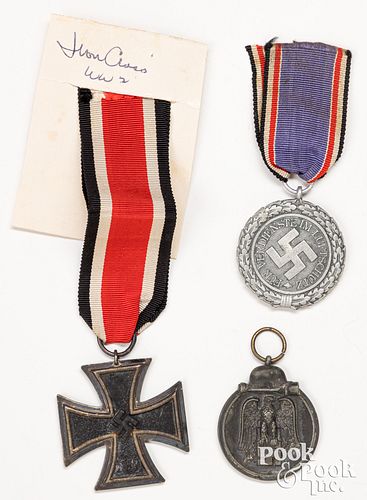 Three German WWII medals, to include an Iron Cross