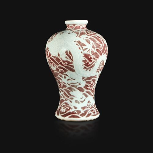 A Chinese carved and underglaze red "Dragons and Waves" vase, Meiping Yongzheng six-character mark and of the period