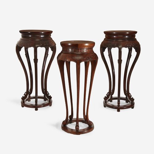 A pair of Chinese hardwood circular stands, together with a similar Chinese carved hardwood circular stand
