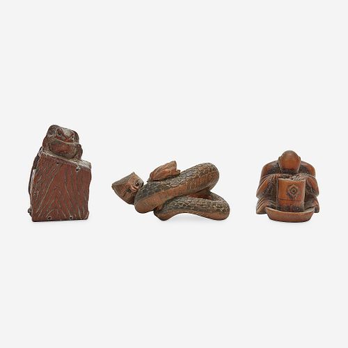 Three Japanese carved wood netsuke: measure and toad, snake and toad, monk and jar