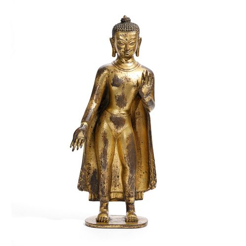 A GILT-BRONZE FIGURE OF STANDING BUDDHA, TIBET
