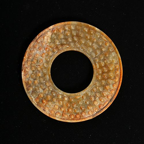 A JADE DISC WITH 'GRAINS' PATTERN