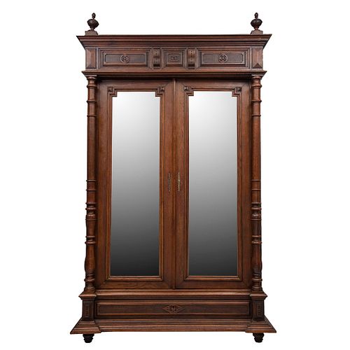 Armario.  Francia.  Siglo XX.  Estilo Enrique II.  En talla de madera de nogal.  Con 2 puertas abatibles, con espejo.
