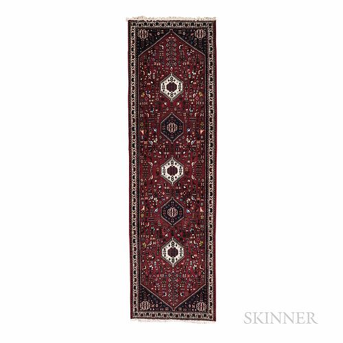 Abadeh Runner, Iran, c. 1980, with five hexagonal medallions on the cranberry red field, 9 ft. 7 in. x 2 ft. 10 in.