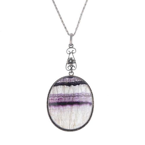 A Blue John pendant Of oval section with lilac and dark amethyst parallel veining, 29mm x 37mm, in w