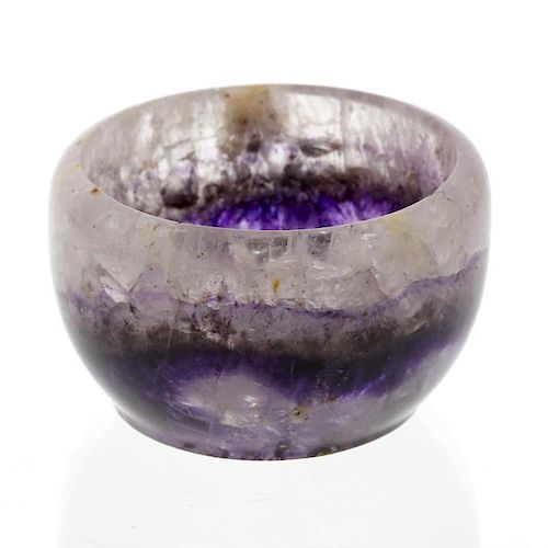 A small Blue John bowl.  The hemispherical body with a medial band of violet veining beneath pale ri