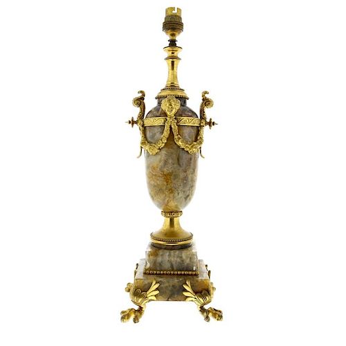 A Crich spar and ormolu lamp base The rounded cylindrical body with waisted neck over female masks,