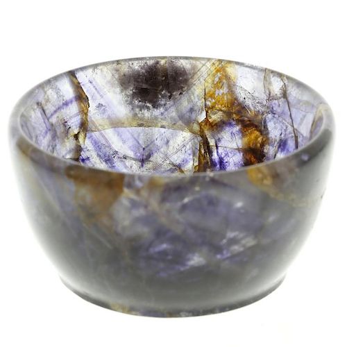 A small Blue John bowl. Of steep-sided circular form shading from translucent lilac to dark violet,