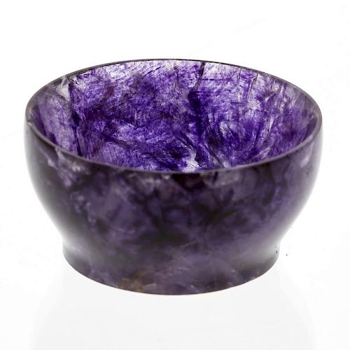 A small Blue John bowl.  Of footed hemispherical form with lilac and violet marbling, 45mm diameter