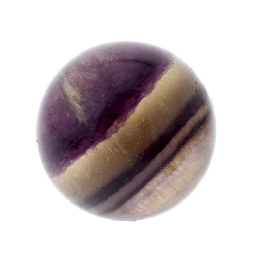A fluorite marble. Of spherical form with clear and violet banding, 28mm diameter, 47gms. VGC.