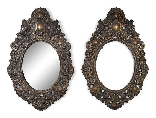 A Pair of Baroque Style Repouseed Brass Mirrors
Height 48 1/2 x width 32 inches.