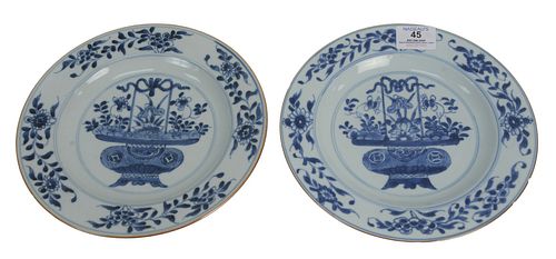Set of Eight Blue and White Plates having painted central floral basket, 19th century, diameter 9 inches.