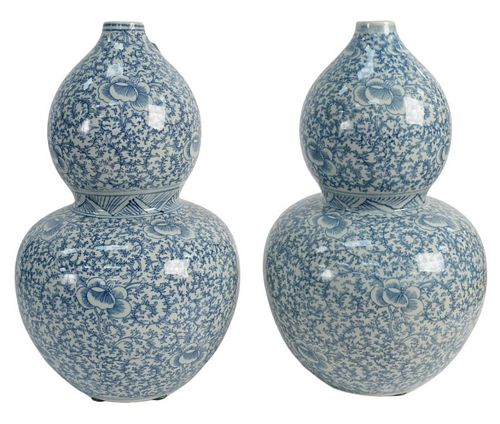 Pair of Blue and White Chinese Double Gourd Vases decorated with flowers and scrolling foliage, height 15 inches. The Estate of Gloria Schiff, 630 Par