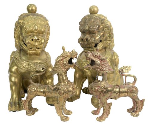 Two Pairs of Brass Foo Dogs to include a pair of large seated Chinese guardian lions, height 19 inches, along with a pair of standing foo lions, heigh