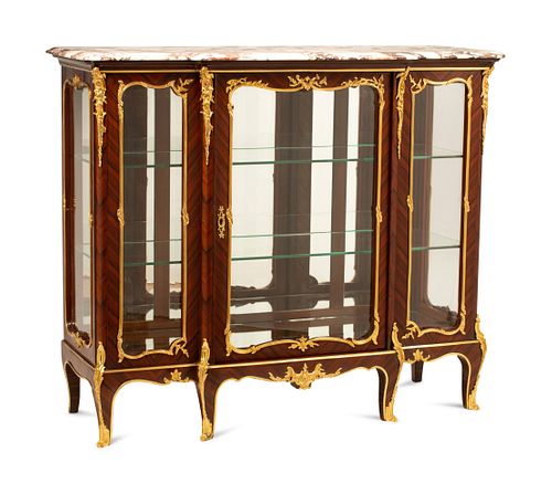 A Louis XV Style Gilt Bronze Mounted Marble-Top Vitrine Cabinet
Height 43 x width 50 1/2 x depth 19 inches.