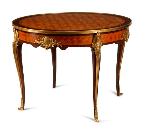 A Louis XV Style Gilt Bronze Mounted Gueridon
Height 29 1/2 x diameter of top 40 inches.