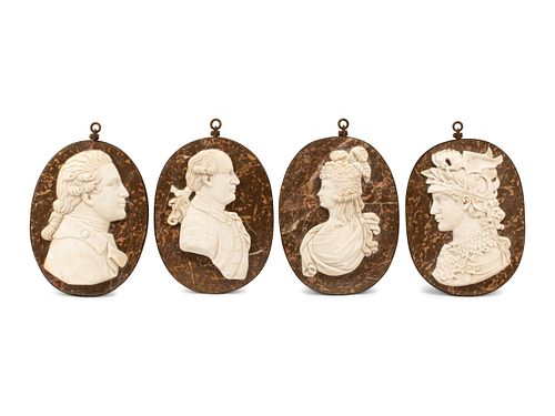 A Set of Four Iron-Framed Marble Portrait Medallions
Height 17 1/2 x width 12 inches.