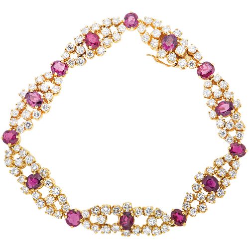 BRACELET WITH RUBIES AND DIAMONDS IN 18K YELLOW GOLD with 14 oval cut rubies ~7.07 ct and 112 brilliant cut diamonds ~5.60 ct