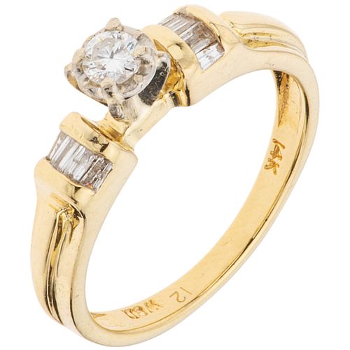 RING WITH DIAMONDS IN 14K YELLOW GOLD with 9 brilliant and trapezoid baguette cut diamonds ~0.24 ct. Weight: 3.3 g. Size: 6 ½
