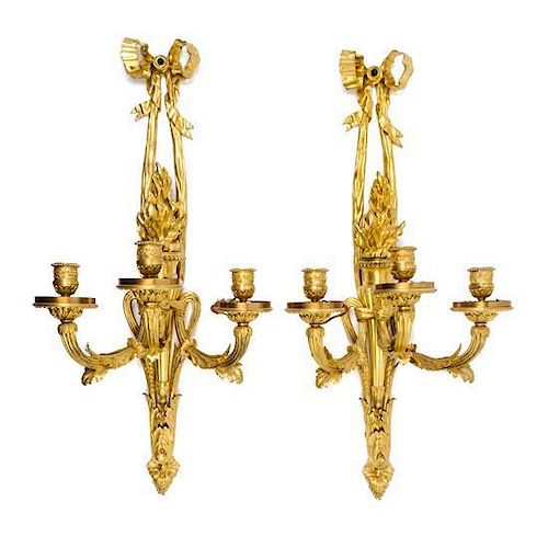 A Pair of Louis XVI Gilt Bronze Three-Light Sconces Height 30 1/2 x width 14 1/2 inches.