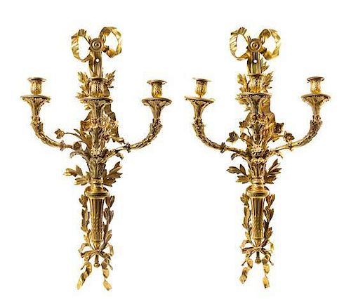 A Pair of Louis XVI Gilt Bronze Three-Light Sconces Height 30 1/2 x width 16 3/4 inches.