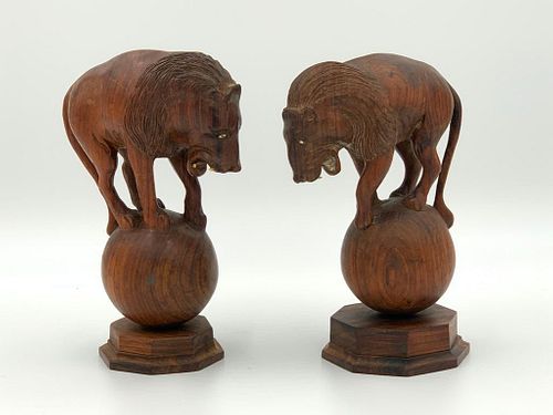Pair of Carved Rosewood Lions on Spheres