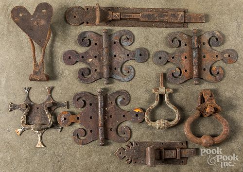 Antique iron door latches, knockers and hinges.