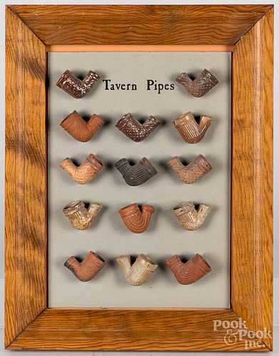 Framed group of earthenware tavern pipes