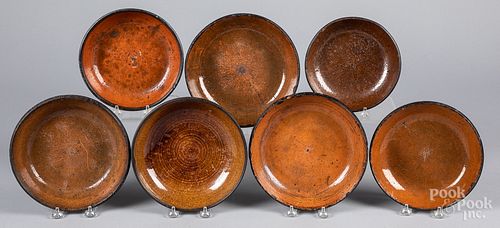 Thirteen redware plates and shallow bowls, 19th c.