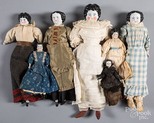 Seven molded hair bisque head dolls.