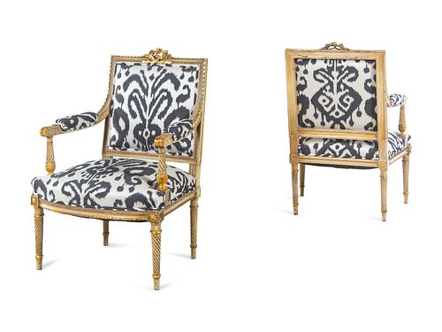 A Pair of Louis XVI Style Brunschwig & Fils Upholstered Cream-Painted and Parcel Gilt Fauteuils
