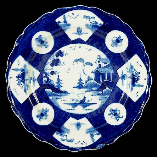 A BOW POWDER BLUE GROUND PLATE, C1758-62 painted with round and fan shaped panels of Chinese