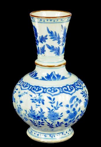 A CHINESE BLUE AND WHITE VASE, KANGXI  with lobed body and flared neck, painted with flowers, the