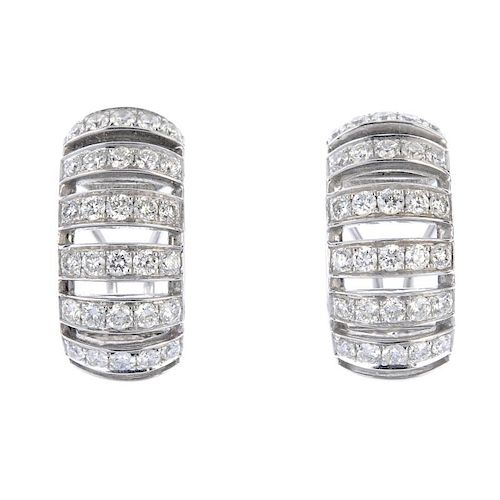 A pair of diamond earrings. Each designed as a series of brilliant-cut diamond curved lines. Estimat