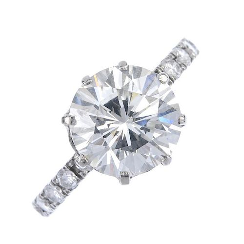 A diamond single-stone ring. The brilliant-cut diamond, weighing 4.69cts, to the similarly-cut diamo