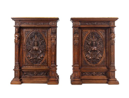 A Pair of Renaissance Revival Carved Walnut Marble Top Cabinets