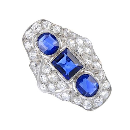 A mid 20th century platinum sapphire and diamond ring. The square and oval-shape sapphires, with old