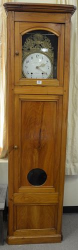French Fruitwood Tall Clock having brass works, porcelain dial, with pendulum and weights, height 83 inches, width 22 1/2 inches, depth 15 inches.