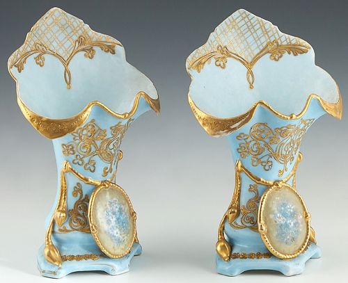 Diminutive Pair of Continental Porcelain Flare Vases, 19th c., with gilt and floral medallion decoration, on a pale blue ground, H.- 11 in., W.- 7 in.