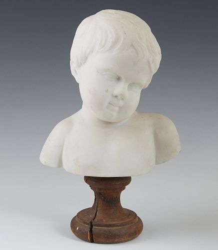 Continental Carved Marble Bust of a Child, late 19th c., on a wooden socle base, H.- 10 5/8 in., W.- 6 1/2 in., D.- 4 1/4 in.