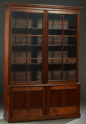 Large American Carved Mahogany Bookcase Cupboard, 19th c., the ogee crown over two mullioned six panel glazed doors, above two lower cupboard doors, o