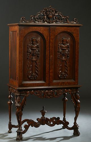 American Carved Walnut Dining Room Cabinet, 20th c., the pierced floral basket crest over a stepped crown above double arched doors with high relief w