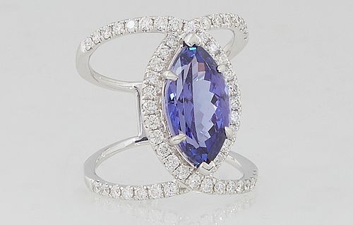 Unusual Lady's 18K White Gold Dinner Ring, with a 5.63 carat marquise tanzanite atop a double split band mounted with round diamonds, total diamond wt