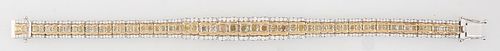 18K Yellow and White Gold Link Bracelet, each of the 28 graduated rectangular links with two cushion cut yellow diamonds, flanked by three small round