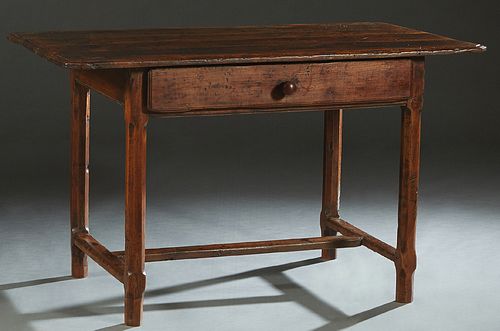 French Provincial Carved Cherry Farmhouse Table, 19th c., the canted corner top over a wide skirt with a long frieze drawer, on tapered chamfered tres